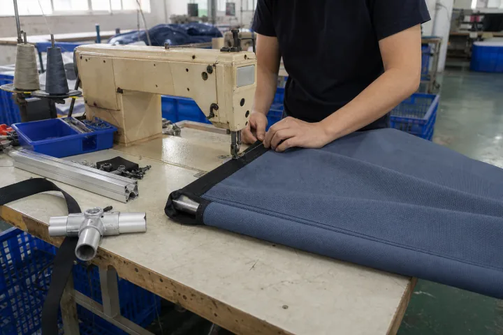 Reinforced fabric edge being sewn beside event display hardware
